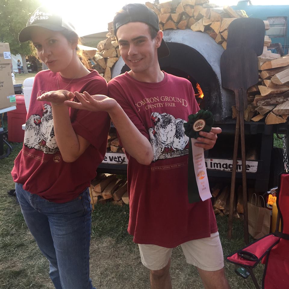 Two employees standing in front of mobile oven