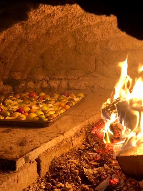 Tomatoes roasting in clay oven